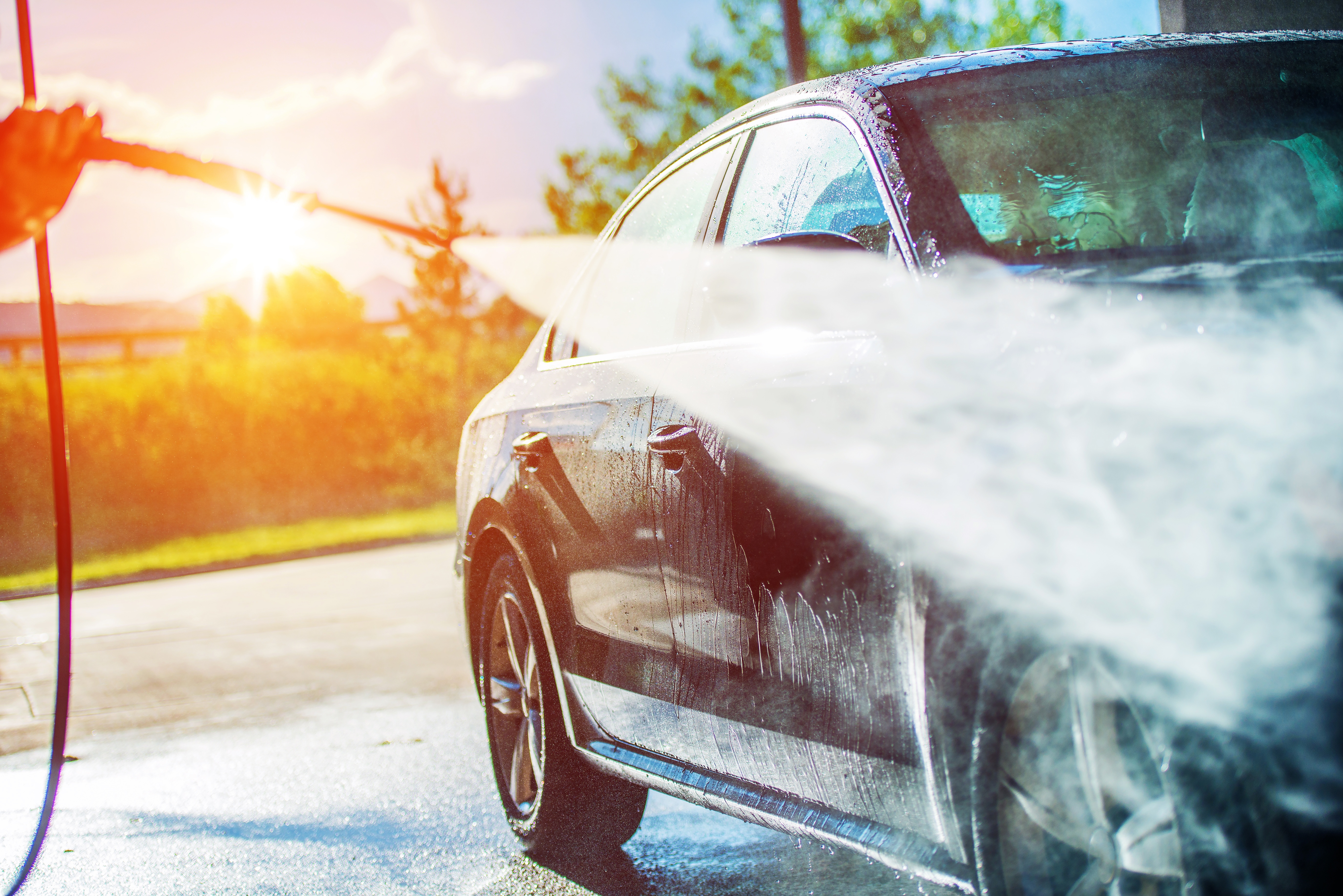 Summer Car Washing. Cleaning Car Using High Pressure Water.